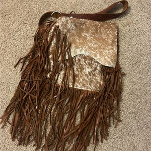 Hand made hair on hide cross body pocket book with tooled strap